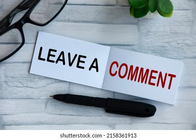 Leave a comment text on notepad with potted plant and glasses background. Feedback concept.