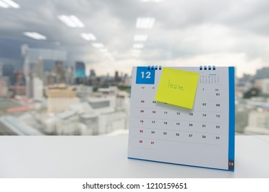Leave on paper note stick on the calendar of December for year end holidays concept