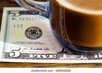 Leave Tipping For The Waiter In The Cafe. A Cup Of Coffee And A 5 Dollar Bill. Selective Focus.