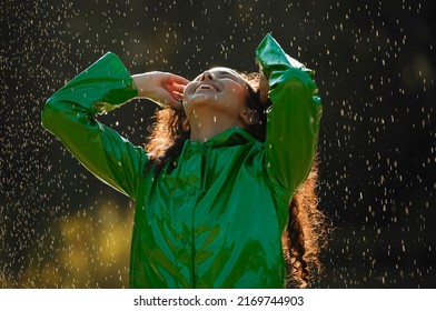 Leave The Umbrella At Home And Live Your Life. Shot Of A Beautiful Young Woman Having Fun In The Rain.