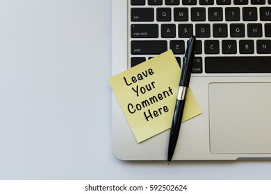 LEAVE YOUR COMMENT HERE Word Concept On Sticky Note, A Pen And Partial Of Laptop Keyboard Over Top View Flat Lay Isolated On White Background.