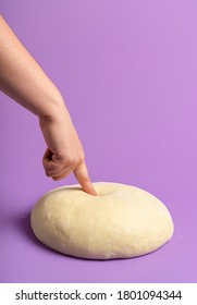 Leavened Bread Dough Isolated On A Purple Seamless Background. Woman Checking Dough. Home Baking Concept. Ready To Bake Raw Dough. Making Bread Buns.