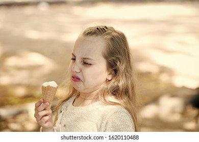 It Leaves A Bad Taste In The Mouth. Cute Little Girl Dislike Taste Of Ice Cream. Small Child Licking Ice Cream With Unpleasant Taste Impression. Her Ice-cream Just Doesnt Taste As Good.