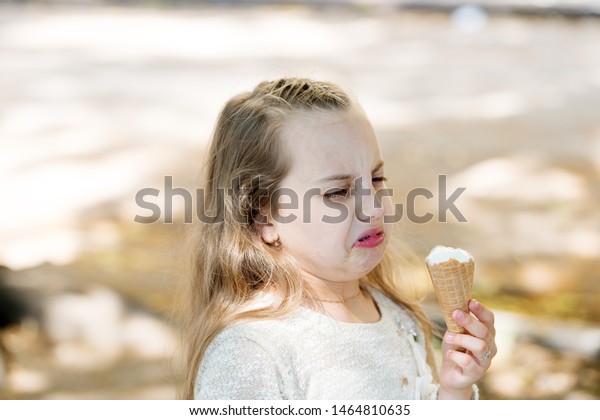 It\
leaves a bad taste in the mouth. Cute little girl dislike taste of\
ice cream. Small child licking ice cream with unpleasant taste\
impression. Her ice-cream just doesnt taste as\
good.