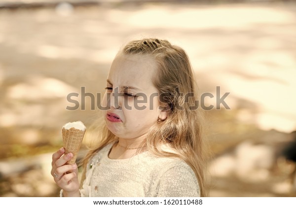 It\
leaves a bad taste in the mouth. Cute little girl dislike taste of\
ice cream. Small child licking ice cream with unpleasant taste\
impression. Her ice-cream just doesnt taste as\
good.