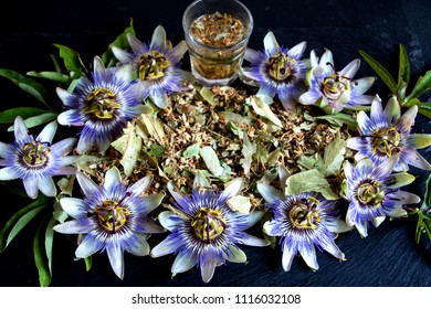 Leaves And Flowers Of The Passion Flower And A Small Glass Of Tea
