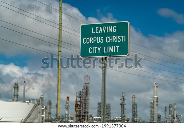 Leaving Corpus Christi City Limits Sign surrounded by\
Oil Refineries 