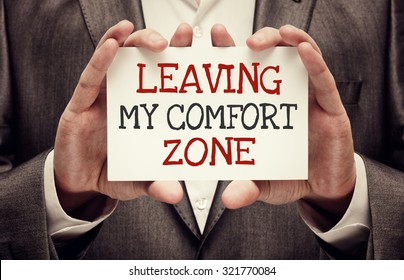 Leaving My Comfort Zone. Businessman Holding A Card With Motivational Message