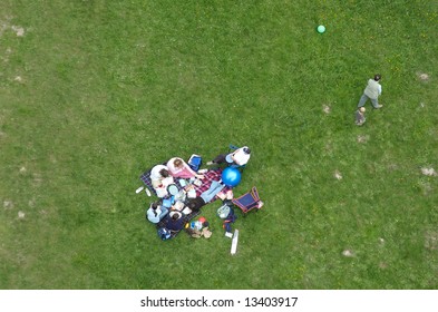 Leaving The Picnic - Overhead Shot Of A Family Group