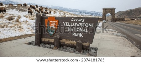 The leaving sign for Yellowstone National Park with iconic Northwest gate.