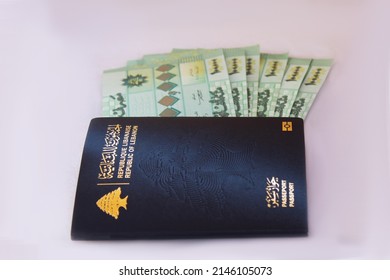 Lebanese Passport next to Lebanese Lira money on a white background, Lebanon, Beirut, Tripoli, Lebanese Lira, Dollar, Crisis, Passport Crisis, Lebanese Crisis.