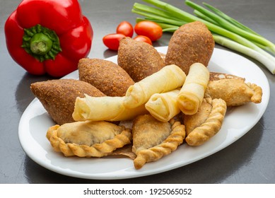 Lebanese Plate of Kebbeh, cheese rolls and meat pie isolated on white
