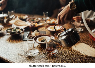 Lebanon Cuisine Served In Restaurant. A Young Company Of People Is Smoking A Hookah And Communicating In An Oriental Restaurant. Traditional Meze Lunch