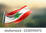 Lebanon flag waving with beautiful background. The flag blowing with green blur background. Lebanon national flag for independence day.