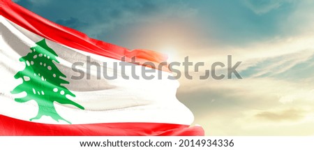 Lebanon national flag waving in beautiful sky.