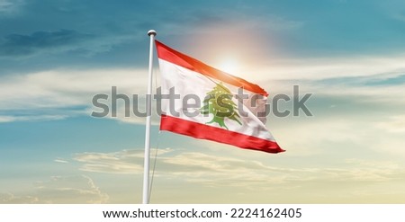 Lebanon national flag waving in beautiful clouds.