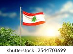 Lebanon national flag waving in greenery. The flag blowing in beautiful sunlight with blue sky. Lebanon national flag for independence day.