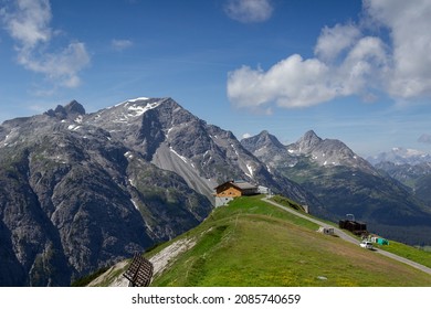 Lech, Austria - August 1 2019: Balmalp alpine hut (2100 m), near the summit of Kriegerhorn, Vorarlberg mountains. Backdrop is Unterer Schafberg and Mehlsack mountain.