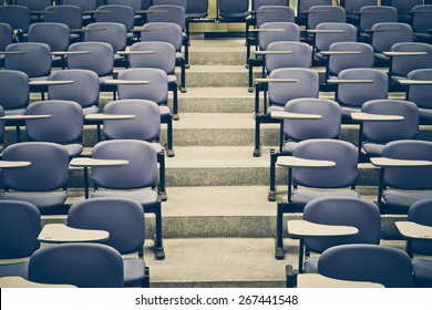 Lecture chairs in a class room with stair path in the middle of a class - Shutterstock ID 267441548