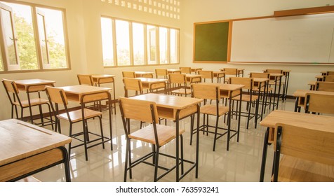 Lecture room or School empty classroom with desks and chair iron wood for studying lessons in high school thailand, interior of secondary education, with whiteboard, vintage tone educational concept