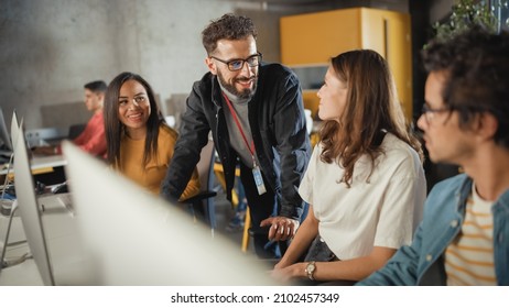 Lecturer Helps Scholar with Project, Advising on Their Work. Teacher Giving Lesson to Diverse Multiethnic Group of Female and Male Students in College Room, Teaching New Academic Skills on a Computer. - Shutterstock ID 2102457349