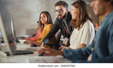 Lecturer Helps Scholar with Project, Advising on Their Work. Teacher Giving Lesson to Diverse Multiethnic Group of Female and Male Students in College, Teaching Computer Science and Writing Code. - Shutterstock ID 2102457361