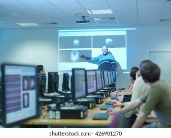 Lecturer Teaching Neuroimaging Students At Workstations