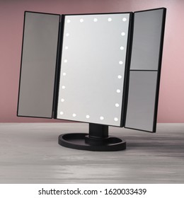 LED Black Vanity Make Up Mirror On White Wooden Table And Pink Background