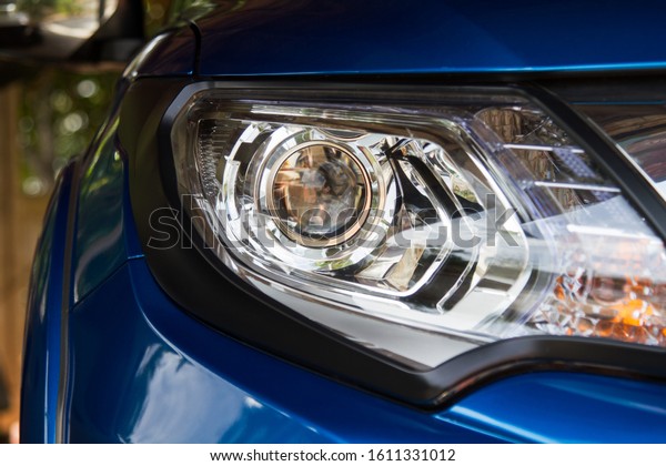 Led car headlight close-up. New modern vehicle\
detail of lamps light