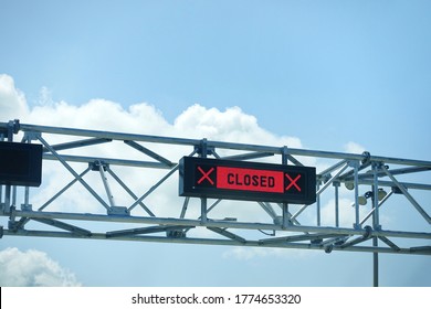 LED Closed Sign At Country Border Gate Against Blue Sky. Border Closed In Coronavirus Pandemic Lockdown To Restrict Non-essential Travel. Multiple Countries Ban UK Travellers Due To New Covid Variant.