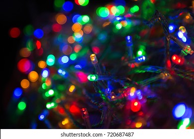 LED Electric Christmas Lights On Wooden Background