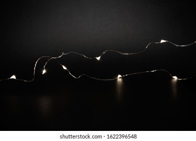 LED Fairy String Warm Small Tiny Lights A Black Background. Minimalist Black