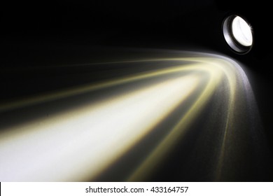 LED flashlight with a light beam at night.
