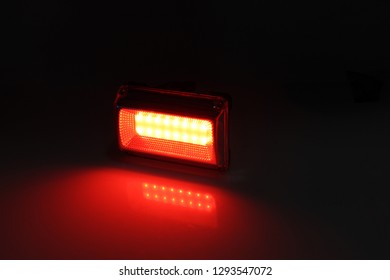 LED flashlight with red light on a black background