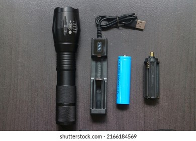 LED Flashlight Set, Black Handle, Torch Head Is Black Plastic Close-up View Of Flashlight Isolated On Black Background