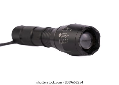 LED flashlight, silver and black handle, torch head is black plastic Close-up of a flashlight isolated on white background