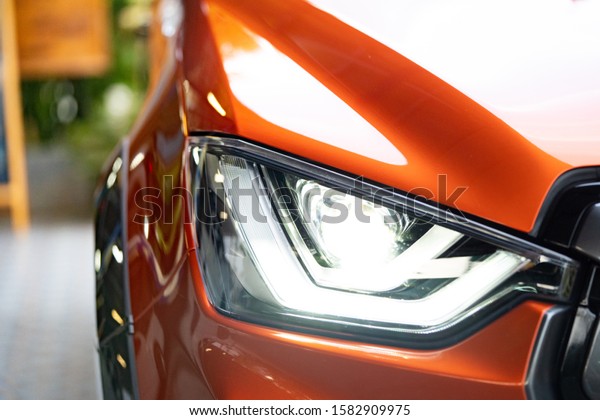 led headlight of new
truck car, Image close-up part of automobile.close up of luxury
orange car head light.