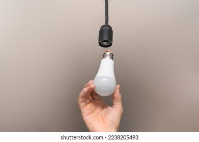 LED lamp in the man's hand. close-up - Shutterstock ID 2238205493
