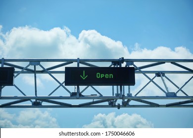 LED lane open sign cross country border against blue sky on highway. Border reopen post covid-19 pandemic lockdown. Canada opens borders to fully vaccinated travellers. US Canada border background.
