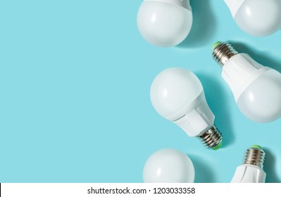 LED light bulbs on blue color background. Flat lay. Pattern.
