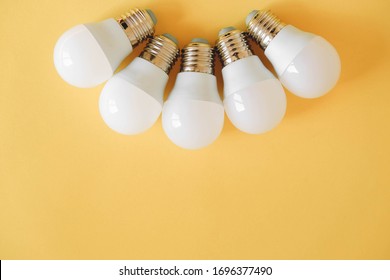 LED light bulbs on yellow background. Top view. Copy, empty space for text