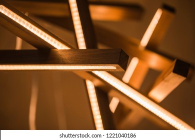 Led Light Lamp Illuminated. Installation Of A Geometric Hanging Wooden Chandelier.