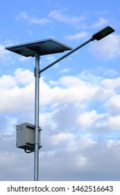 Led Light And Solar Cell Panel On Pole For Saving Energy Have Blue Sky And Clound Background.