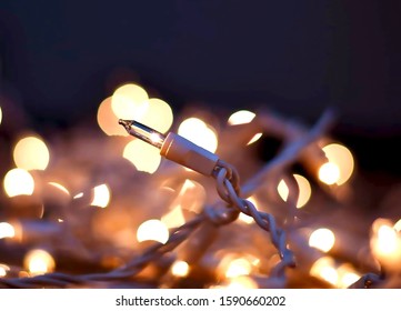 LED lights garland, colorful light bulbs on a bokeh background.Part of Christmas decorative silver, white, yellow, golden flashing lights. Detail of New Year and Christmas decorations, string rice. - Powered by Shutterstock