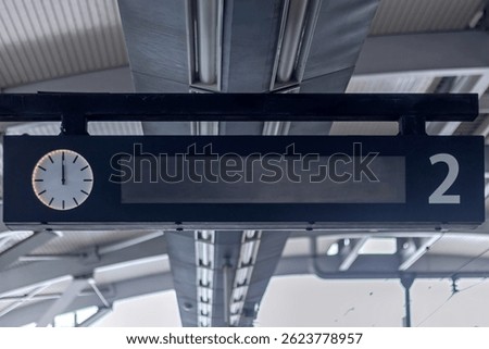 LED panel display with analog clock in the train station. Train Schedule Display.