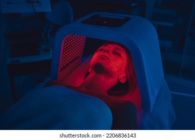 LED Red Light Is Treating The Facial Skin Of A Young Woman. High Quality 4k Footage