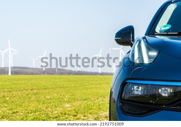 LED\
spotlight on a graphite colored SUV in a wind\
farm