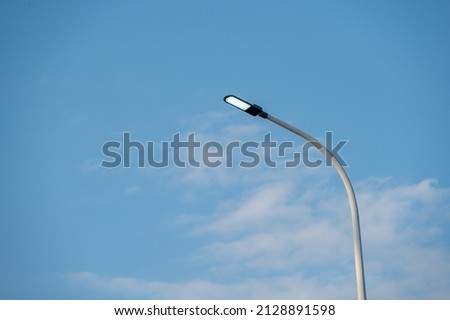 LED street lights lit under the blue sky