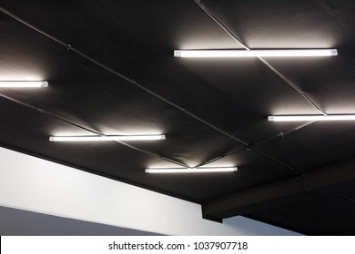 Led Tube Lights On Black Office Ceiling. Minimal Loft Design