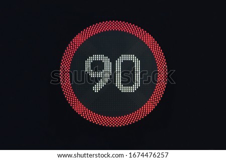LED Variable Speed Limit Sign at night The illuminated sign is reading 90 kilometres per hour. 